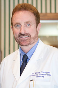 Dr. Flanagan smilng Bio Pic in White doctors coat